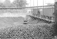in the pit, the front-end loader scoops flushed coal into storage piles